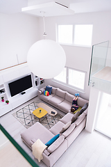 Image showing little girl using a smartphone on the sofa at home