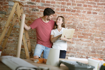 Image showing Young couple doing apartment repair together themselves