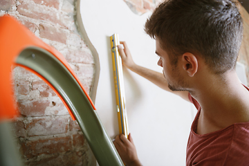 Image showing Young man doing apartment repair hisselfes