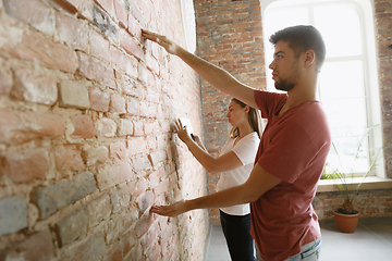 Image showing Young couple doing apartment repair together themselves