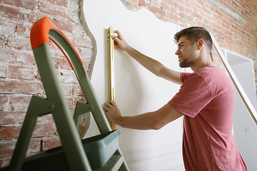 Image showing Young man doing apartment repair hisselfes