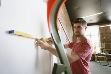 Image showing Young man doing apartment repair hisselfes