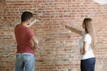 Image showing Young couple doing apartment repair together themselves