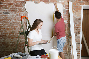 Image showing Young couple doing apartment repair together themselves