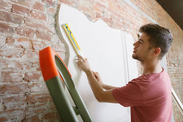 Image showing Young man doing apartment repair hisselfes