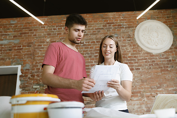 Image showing Young couple doing apartment repair together themselves