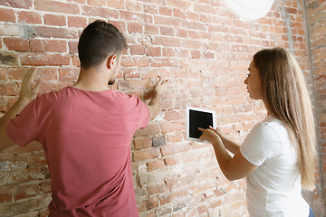 Image showing Young couple doing apartment repair together themselves