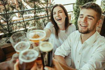 Image showing Young group of friends drinking beer and celebrating together