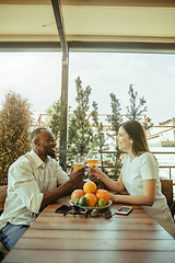 Image showing Young friends or couple drinking beer and celebrating together