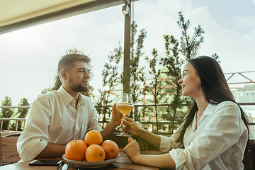 Image showing Young friends or couple drinking beer and celebrating together