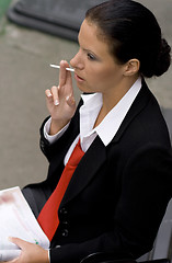 Image showing businesswoman with cigarette