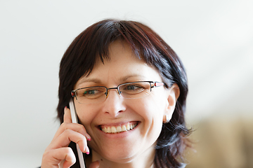 Image showing smiling middle-aged woman call by phone