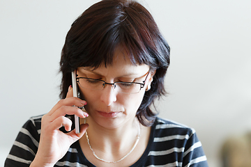 Image showing tired middle-aged woman call by phone