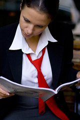 Image showing businesswoman reading magazine