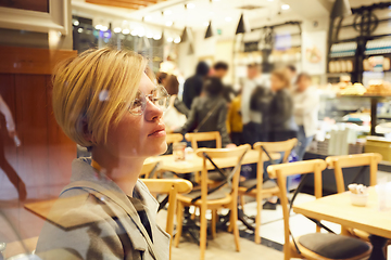 Image showing Closeup portrait of an elegant middle aged woman wearing glasses