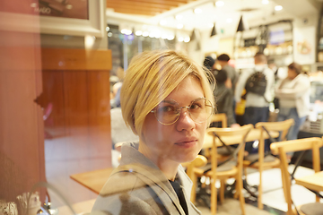 Image showing Closeup portrait of an elegant middle aged woman wearing glasses