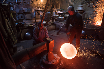 Image showing blacksmith workers using mechanical hammer at workshop