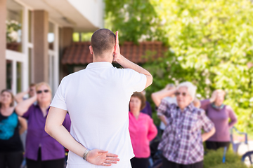 Image showing trainer training motivated active healthy senior people