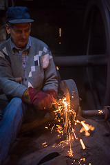 Image showing the blacksmith polishing metal products