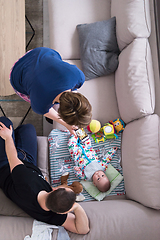 Image showing top view of happy mother and father taking picture of baby