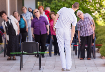 Image showing trainer training motivated active healthy senior people