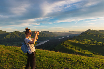 Image showing Woman taking photo in mountain