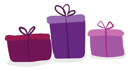Image showing Three colorful present boxes of different colors and shapes tied