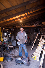 Image showing A blacksmith worker showing handmade products ready for sale