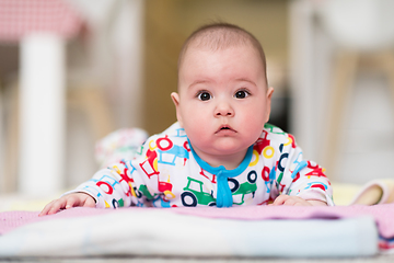 Image showing newborn baby boy playing on the floor