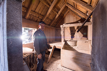 Image showing portrait of a miller in retro wooden watermill