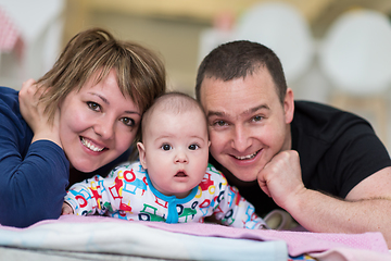 Image showing Portrait of young happy couple with their adorable baby boy