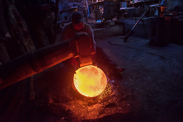 Image showing blacksmith workers using mechanical hammer at workshop