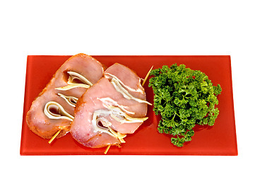 Image showing Tenderloin with ham and cheese on red plate