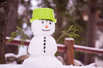 Image showing smiling snowman with green hat