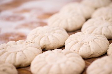 Image showing balls of dough bread getting ready to be baked