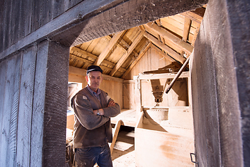 Image showing portrait of a miller in retro wooden watermill