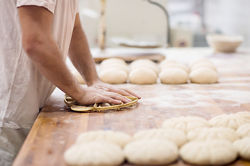 Image showing bakery worker preparing the dough