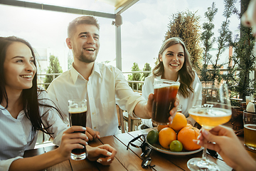 Image showing Young group of friends drinking beer and celebrating together