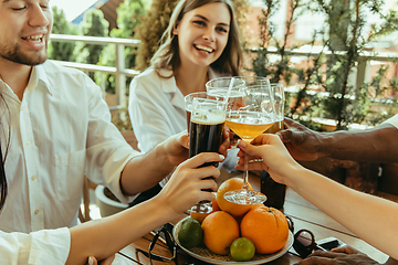 Image showing Young group of friends drinking beer and celebrating together