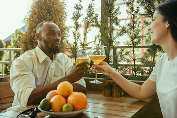 Image showing Young friends or couple drinking beer and celebrating together