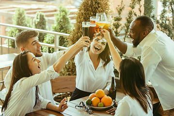 Image showing Young group of friends drinking beer and celebrating together