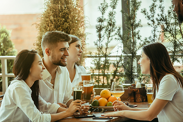 Image showing Young group of friends drinking beer and celebrating together