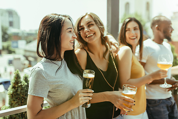 Image showing Young group of friends drinking beer and celebrating together