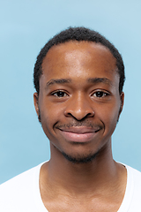 Image showing Close up portrait of young man on blue background.