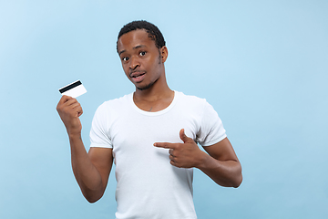 Image showing Half-length close up portrait of young man on blue background.