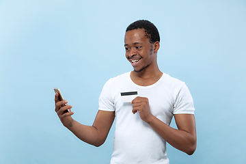 Image showing Half-length close up portrait of young man on blue background.