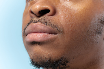 Image showing Close up portrait of young man on blue background.