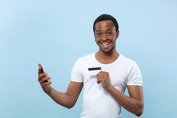 Image showing Half-length close up portrait of young man on blue background.