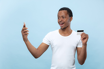 Image showing Half-length close up portrait of young man on blue background.