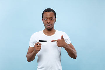 Image showing Half-length close up portrait of young man on blue background.